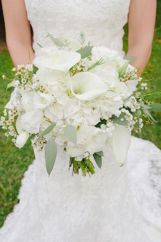 robe de mariée blanche, coupe droite et un bouquet de lys blancs et de fleurs blanches avec un feuillage